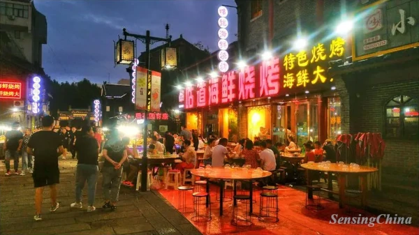 people are enjoying their foods at a night market